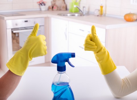 Professional cleaner maintaining shared hallway floors and handrails